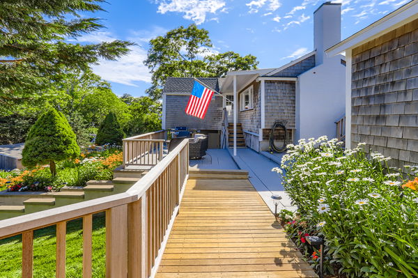 217 Barnes Road Oak Bluffs, MA 02557 - Photo 34 of 60 A front deck and patio flow from the main house to the guest house.