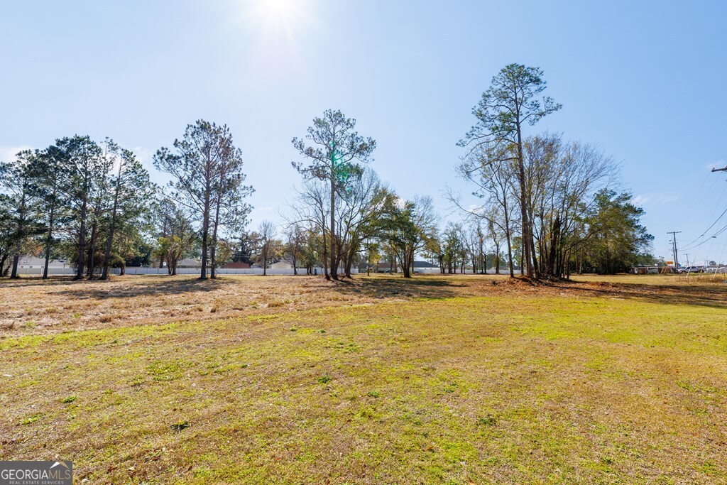 4696 Bemiss Road Valdosta, GA 31605 - Photo 7 of 7 a view of a swimming pool with an outdoor space and seating area