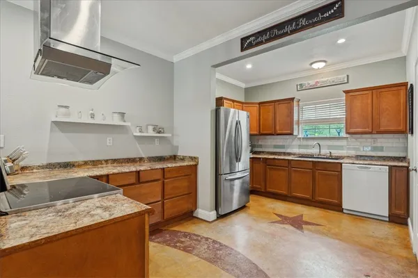 a kitchen with granite countertop cabinets sink and window