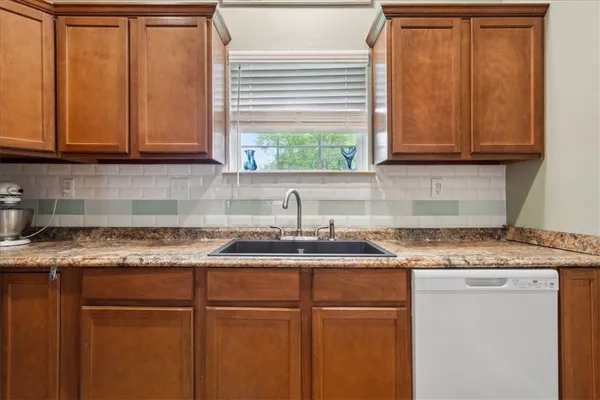 a kitchen with stainless steel appliances granite countertop a refrigerator a stove a sink and a microwave