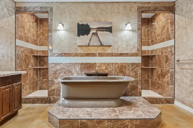 a bathroom with a bathtub and shower