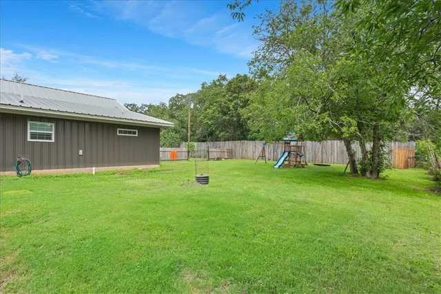 a view of a house with backyard and a slide