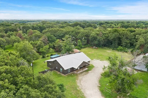 an aerial view of a house with yard