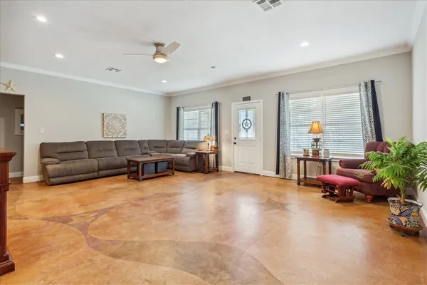 a living room with furniture and wooden floor