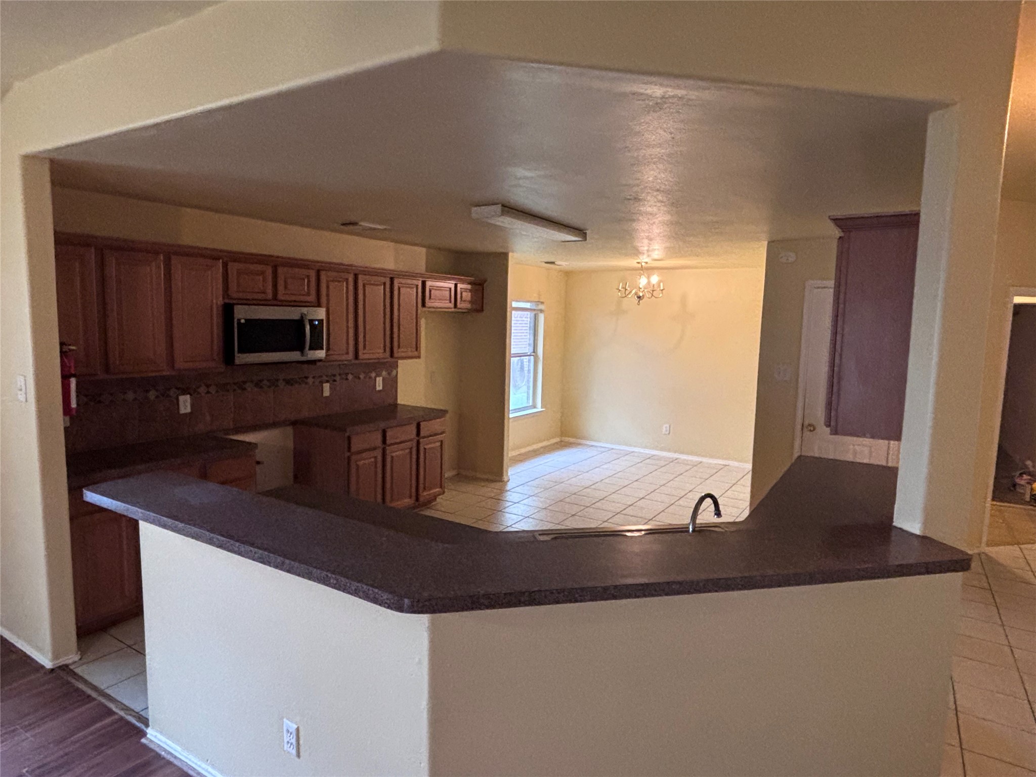 6402 Hayman Drive Katy, TX 77449 - Photo 3 of 9 a kitchen with granite countertop a sink and a refrigerator