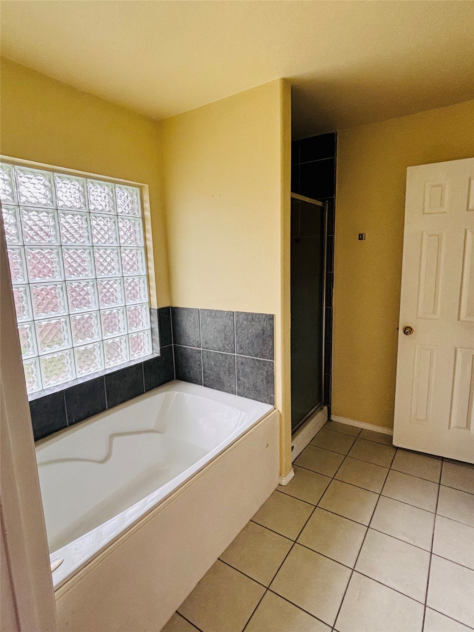 6402 Hayman Drive Katy, TX 77449 - Photo 6 of 9 a bathroom with a bathtub and next to a window