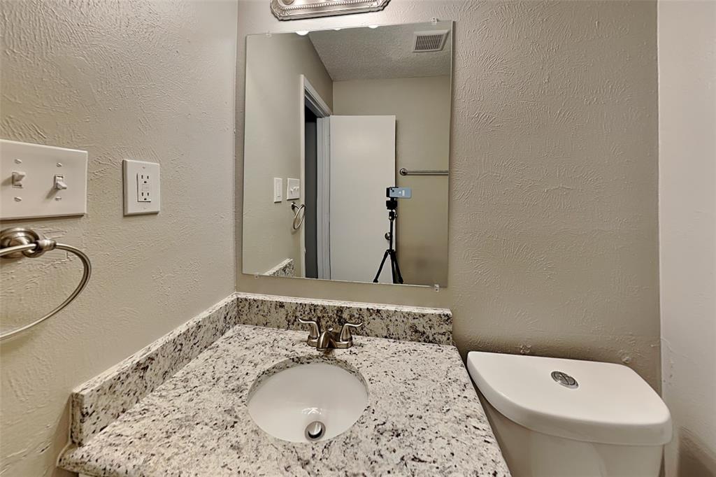 1504 Homestead Street Flower Mound, TX 75028 - Photo 13 of 22 a bathroom with a sink and mirror with toilet