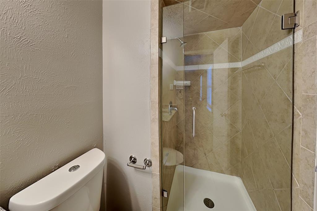 1504 Homestead Street Flower Mound, TX 75028 - Photo 14 of 22 a bathroom with a shower and toilet