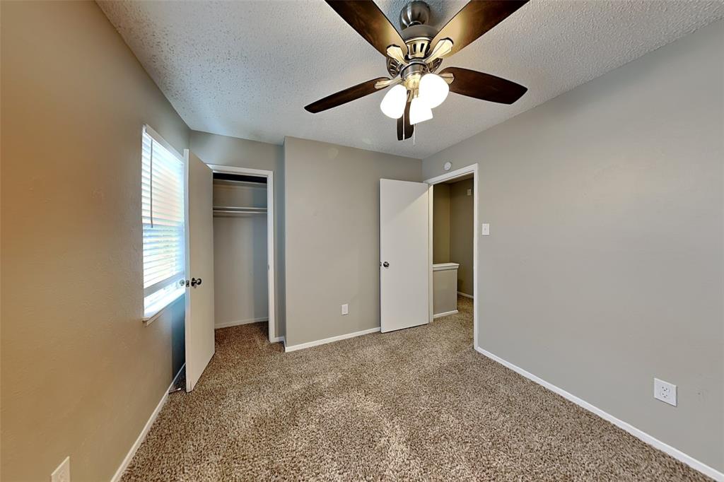 1504 Homestead Street Flower Mound, TX 75028 - Photo 15 of 22 an empty room with chandelier fan and windows