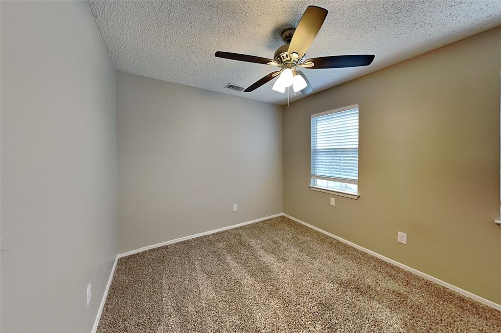 1504 Homestead Street Flower Mound, TX 75028 - Photo 16 of 22 an empty room with a window and a fan