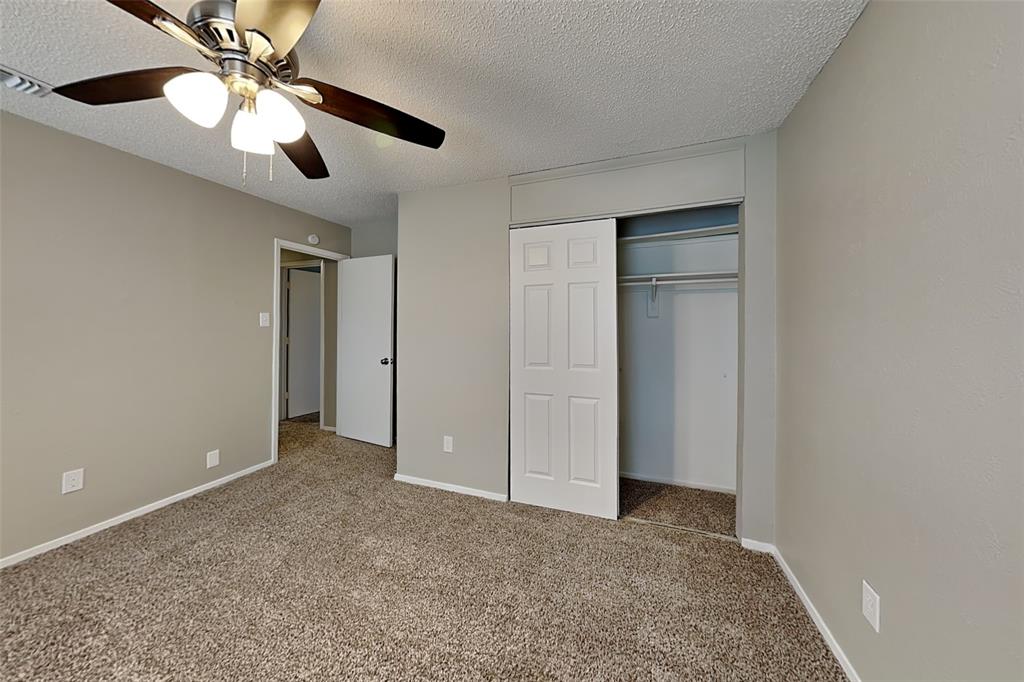 1504 Homestead Street Flower Mound, TX 75028 - Photo 17 of 22 a view of an empty room and chandelier fan