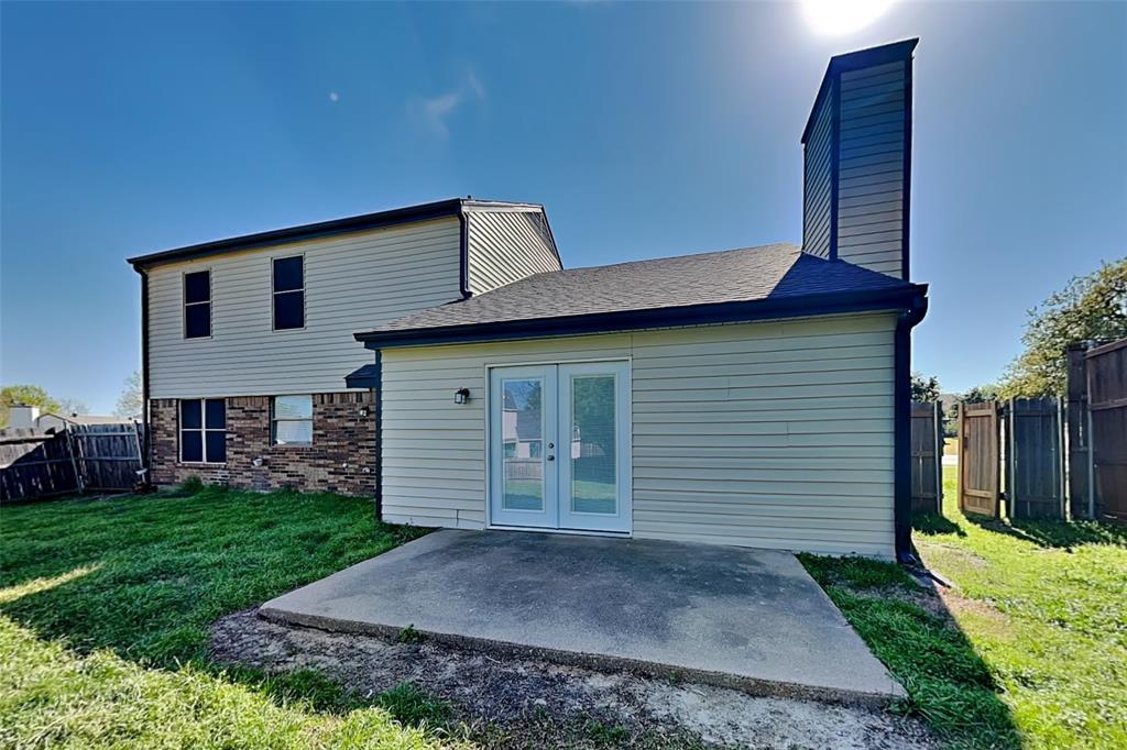 1504 Homestead Street Flower Mound, TX 75028 - Photo 20 of 22 a view of a house with a yard and garage