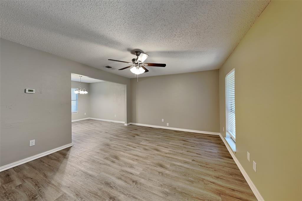 1504 Homestead Street Flower Mound, TX 75028 - Photo 3 of 22 a view of an empty room with wooden floor