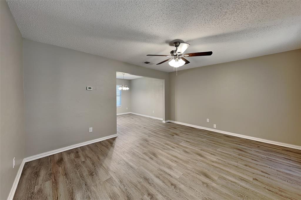 1504 Homestead Street Flower Mound, TX 75028 - Photo 4 of 22 wooden floor in an empty room with a window
