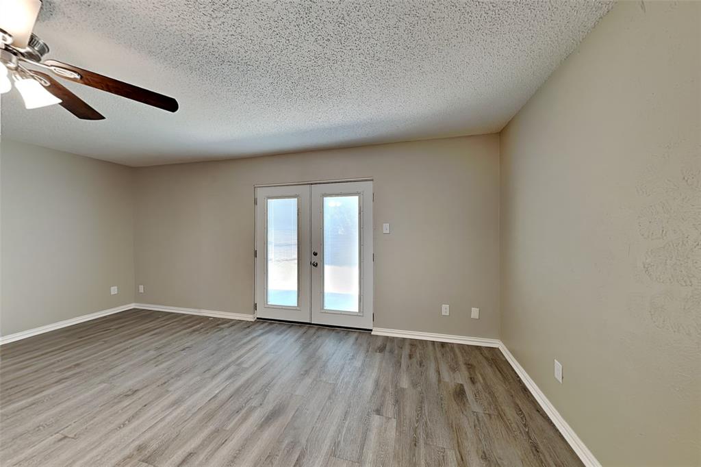 1504 Homestead Street Flower Mound, TX 75028 - Photo 6 of 22 an empty room with wooden floor and windows