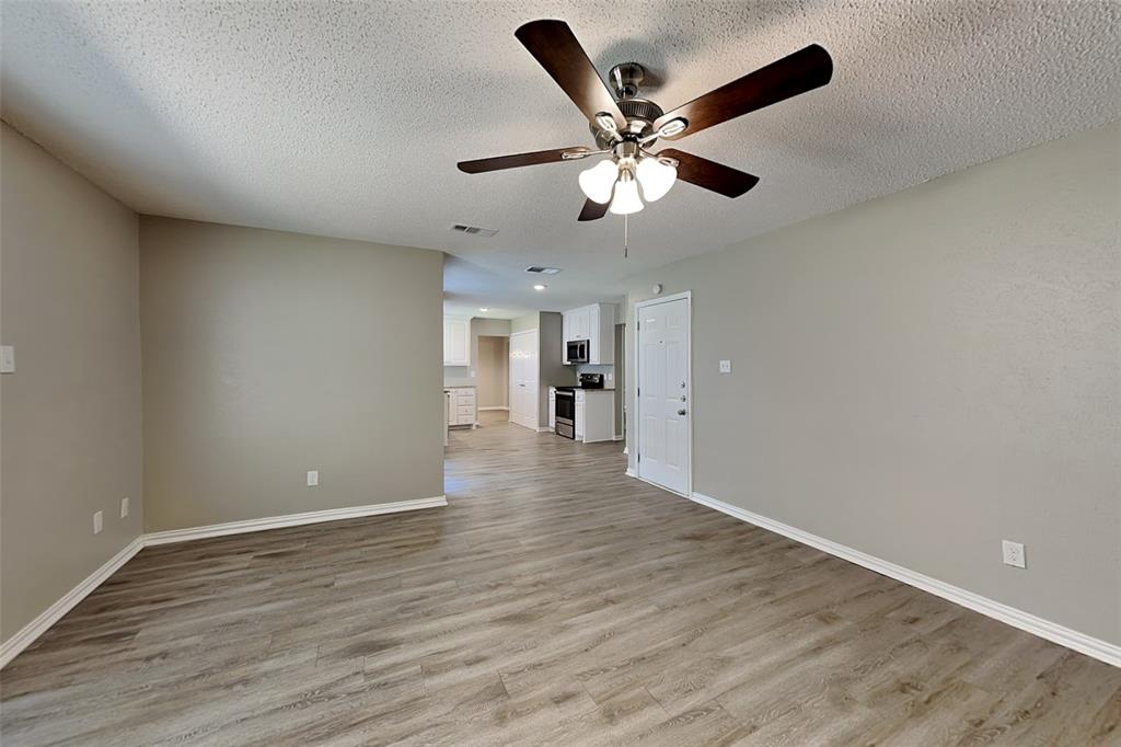 1504 Homestead Street Flower Mound, TX 75028 - Photo 7 of 22 a view of an empty room and wooden floor