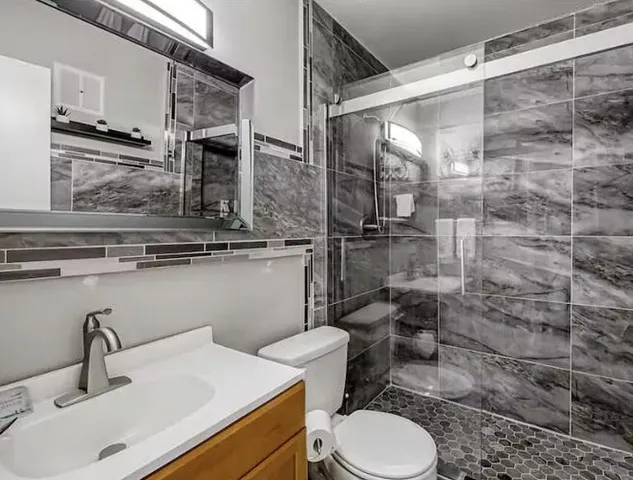 a bathroom with a sink toilet and shower