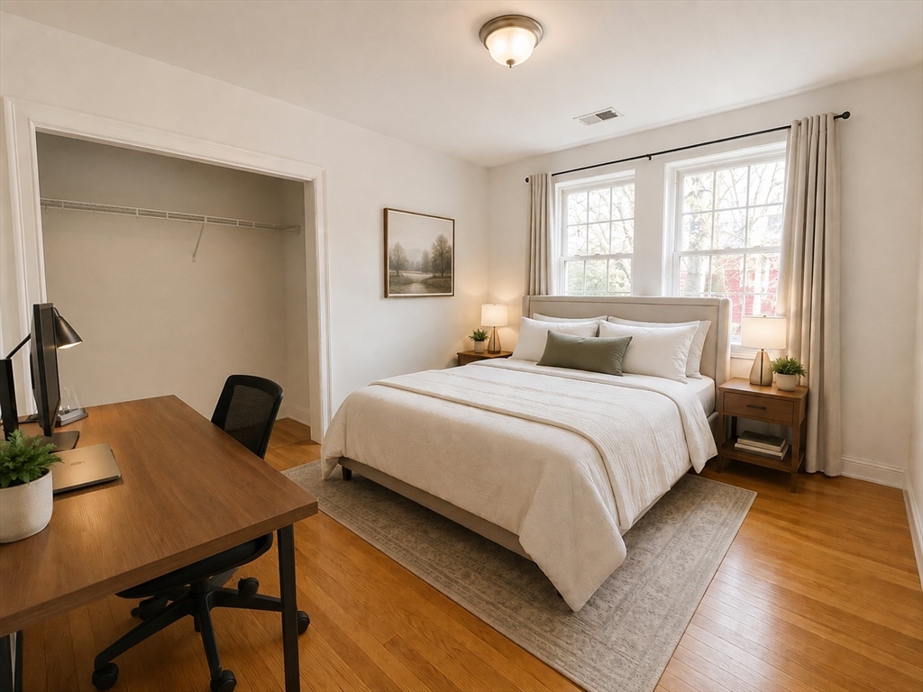 6 Forest Street, Unit 2 Boston, MA 02119 - Photo 4 of 8 a bedroom with a bed and a table in it