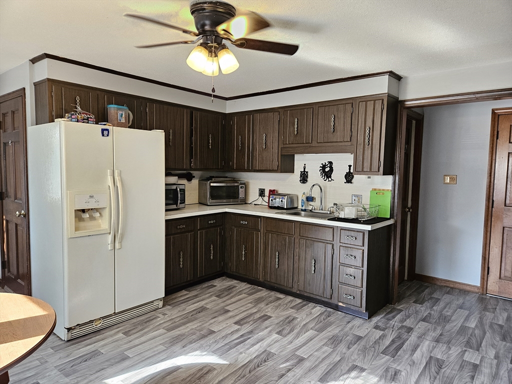 45 Dimmick Street Springfield, MA 01109 - Photo 9 of 22 a kitchen with a refrigerator a sink and cabinets