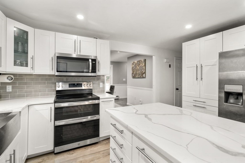 22 Dennison Cross Road Southbridge, MA 01550 - Photo 10 of 38 a kitchen with cabinets stainless steel appliances and wooden floor