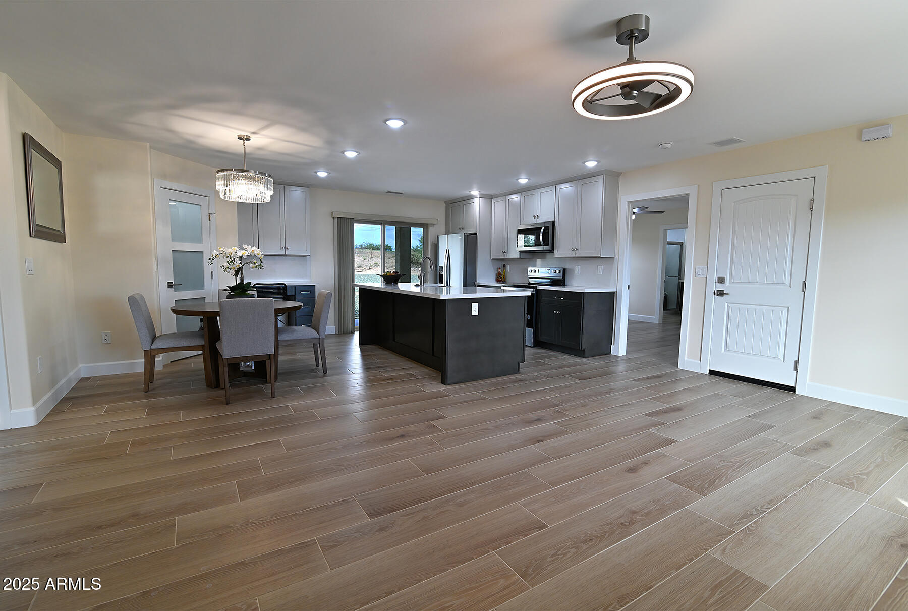 20214 East Mesa Verde Road Mayer, AZ 86333 - Photo 2 of 26 a large kitchen with a table and chairs
