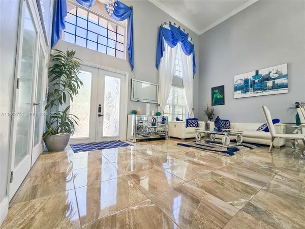 a living room with furniture kitchen and a flat screen tv