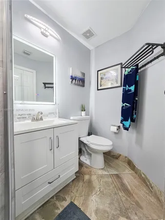 a bathroom with a shower sink and mirror