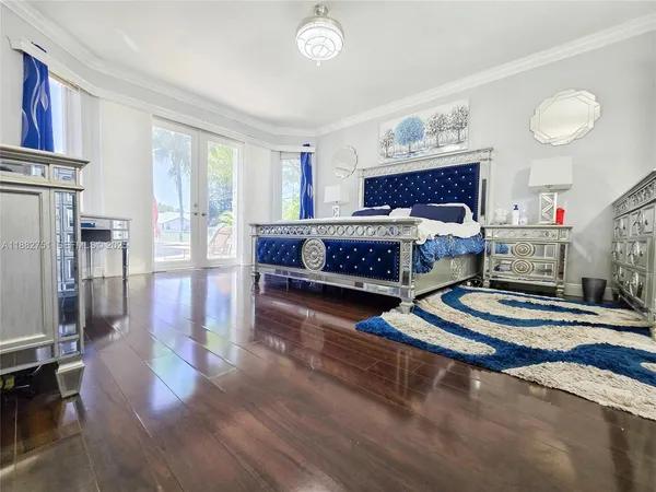 a view of a kitchen with kitchen island a large counter space a sink and appliances