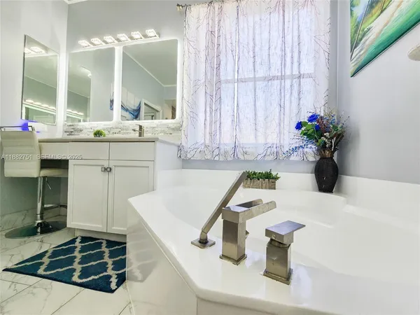 a living room with a dresser and a flat screen tv