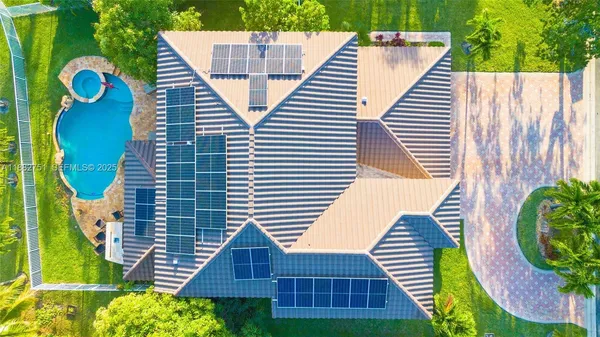 a view of a backyard with plants and wooden fence