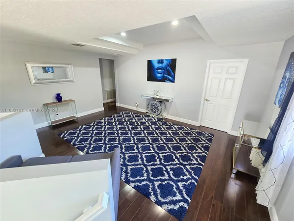 a view of an entryway with wooden floor
