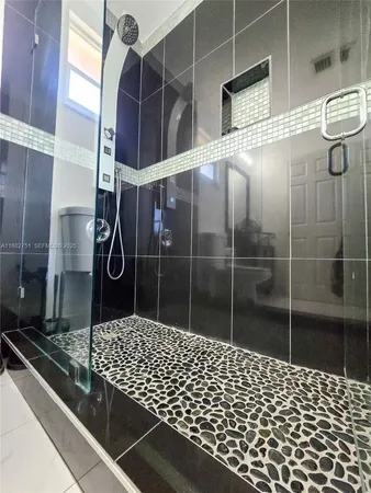 a bathroom with a sink a toilet and a shower