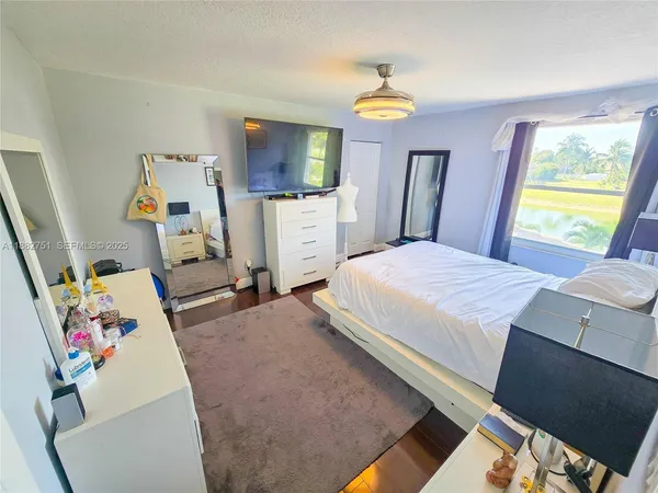 a spacious bathroom with a granite countertop sink a toilet a mirror and shower