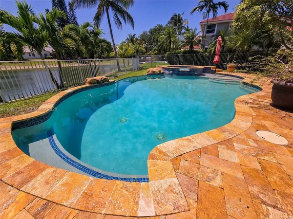 a view of swimming pool with a garden and trees