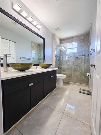 a view of a kitchen with a sink and cabinets