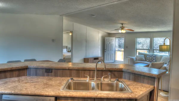 a kitchen with a sink and a refrigerator