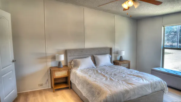 a bedroom with a bed and a chandelier