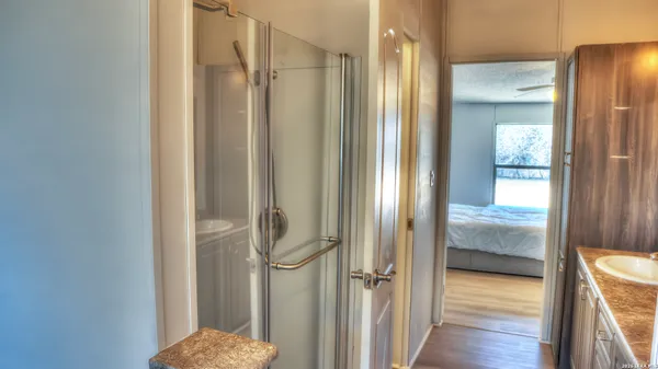a bathroom with a glass shower door