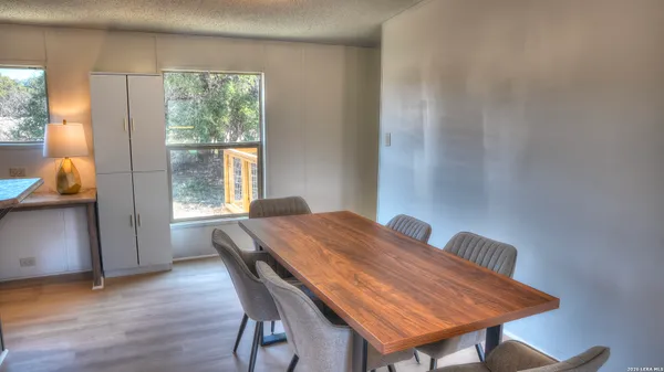 a workspace room with furniture and window