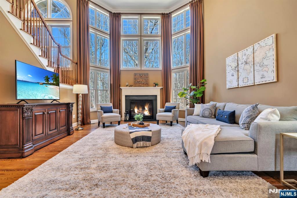 28 Arbor Road North Caldwell, NJ 07006 - Photo 15 of 50 a living room with furniture a fireplace and a flat screen tv