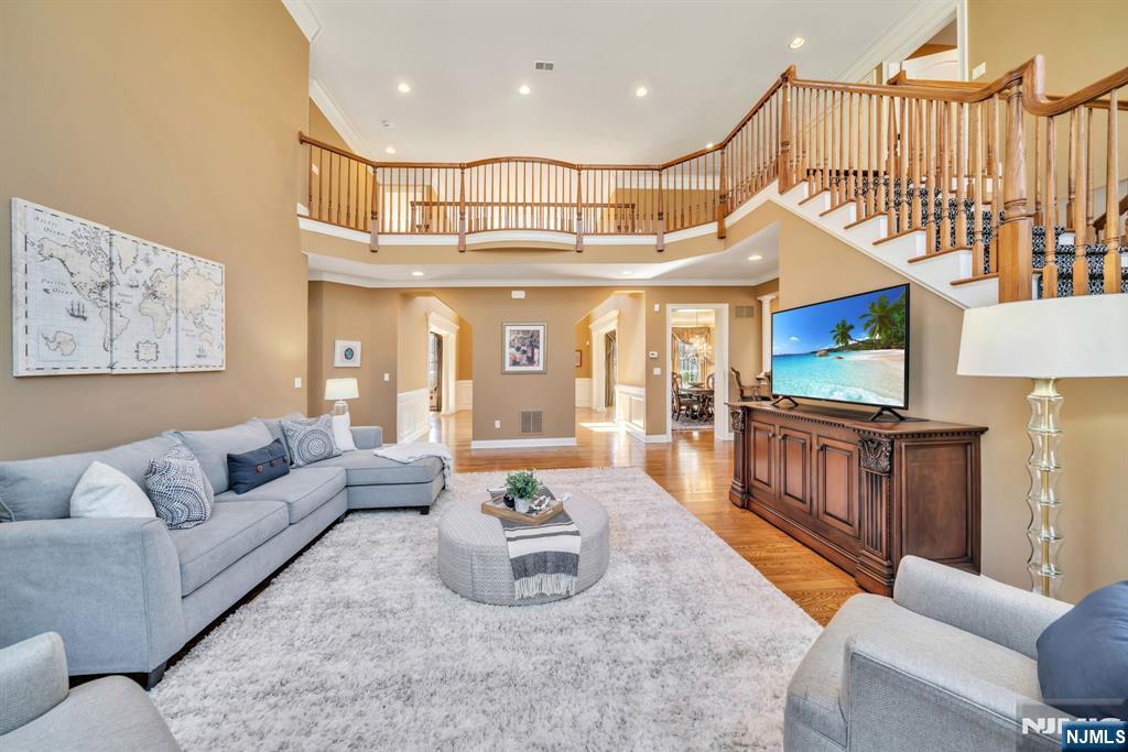 28 Arbor Road North Caldwell, NJ 07006 - Photo 16 of 50 a living room with furniture a wooden floor and a chandelier