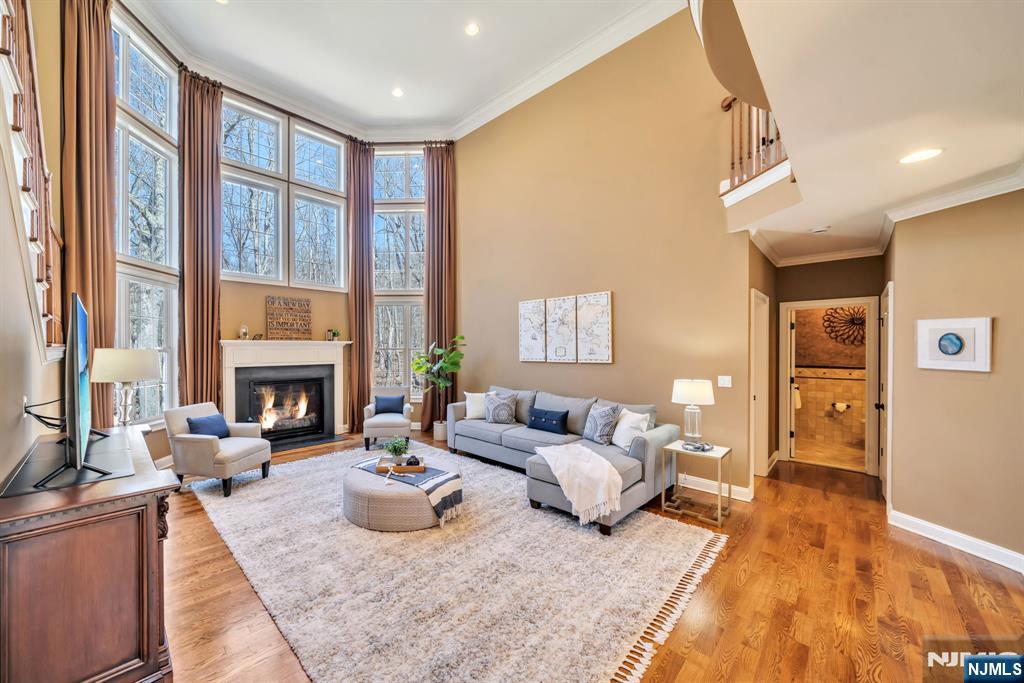 28 Arbor Road North Caldwell, NJ 07006 - Photo 20 of 50 a living room with furniture large window and a fireplace