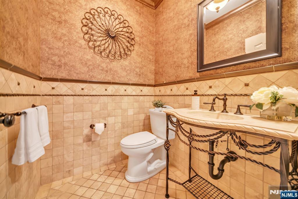 28 Arbor Road North Caldwell, NJ 07006 - Photo 21 of 50 a bathroom with a sink and mirror