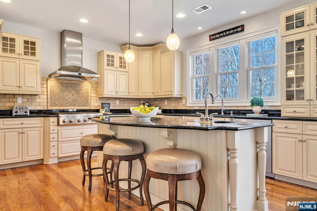 28 Arbor Road North Caldwell, NJ 07006 - Photo 26 of 50 a kitchen with granite countertop white cabinets and chairs