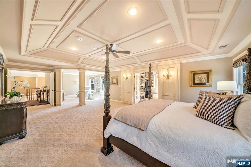 28 Arbor Road North Caldwell, NJ 07006 - Photo 33 of 50 a spacious bedroom with a large bed and a chandelier