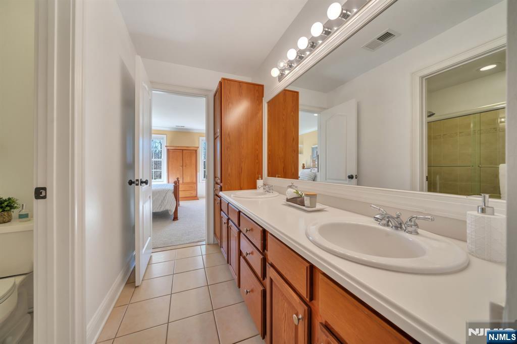 28 Arbor Road North Caldwell, NJ 07006 - Photo 41 of 50 a bathroom with a sink and a mirror