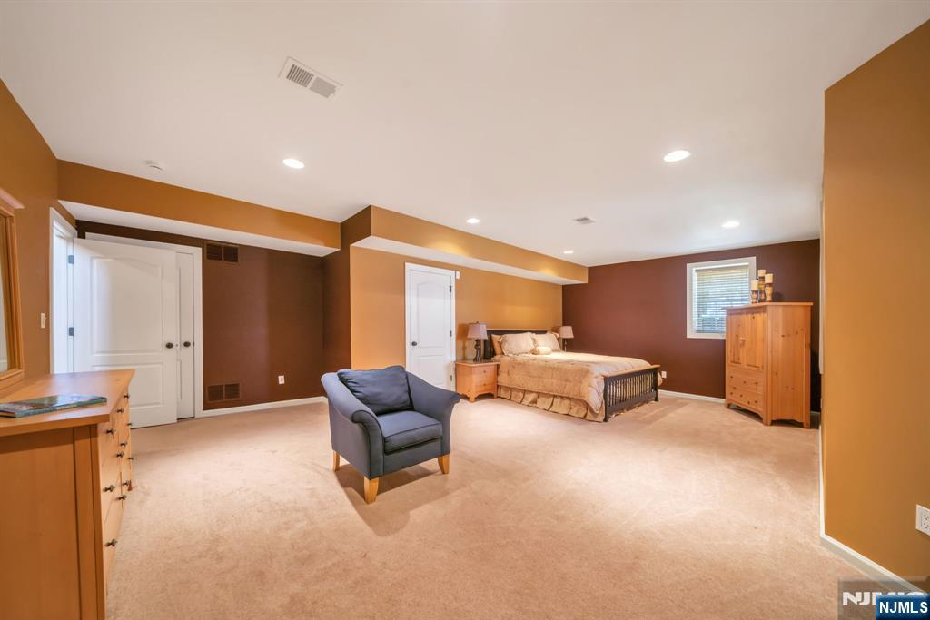 28 Arbor Road North Caldwell, NJ 07006 - Photo 44 of 50 a spacious bedroom with a bed and a couch