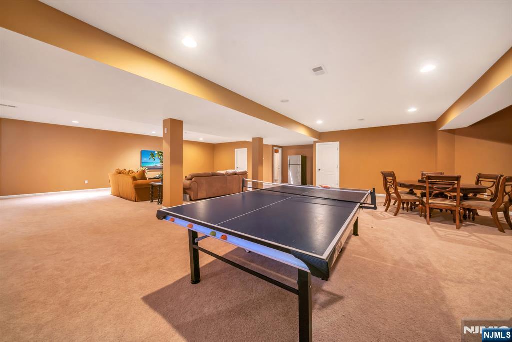 28 Arbor Road North Caldwell, NJ 07006 - Photo 45 of 50 a living room with table tennis table and a potted plant