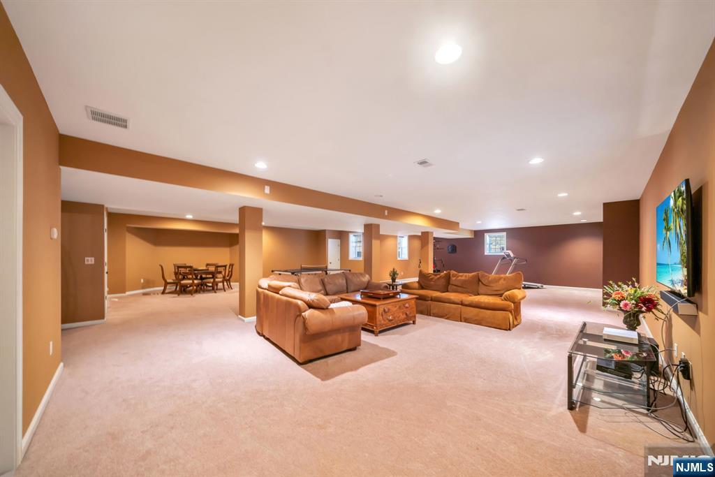 28 Arbor Road North Caldwell, NJ 07006 - Photo 46 of 50 a living room with furniture and a flat screen tv