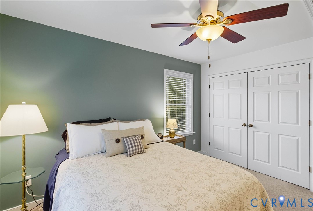 13712 Woodbridge Crossing Way Midlothian, VA 23112 - Photo 26 of 33 a bedroom with a bed and a lamp